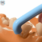 superslim tuft interspace brush in use on teeth